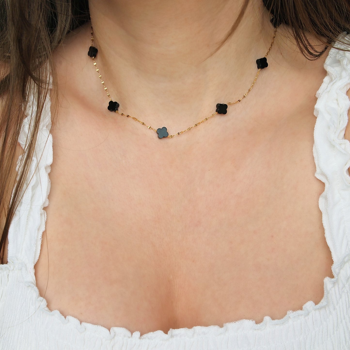 everyday woman necklace with black clover charms