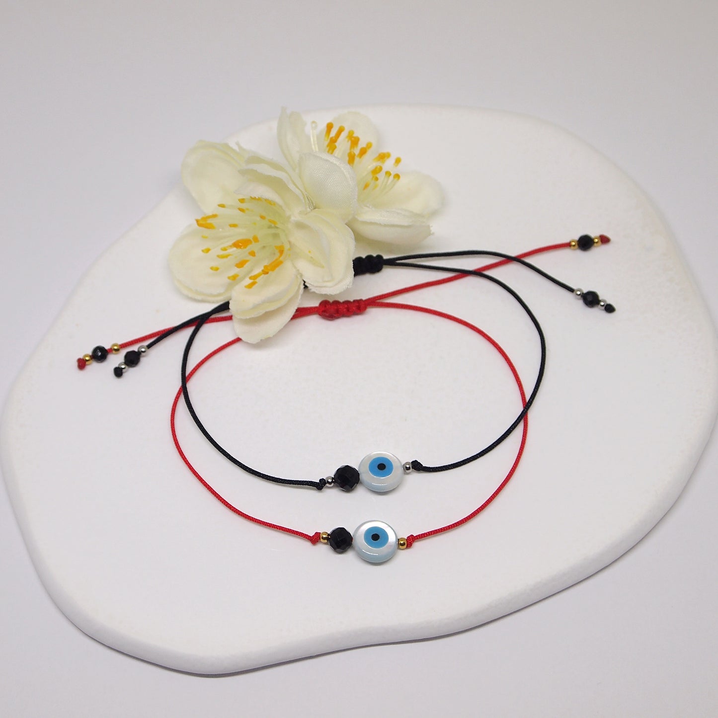 red thread braclet with protection eye and black tourmaline