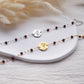 Custom engraved garnet bracelet with january birth flowers and name