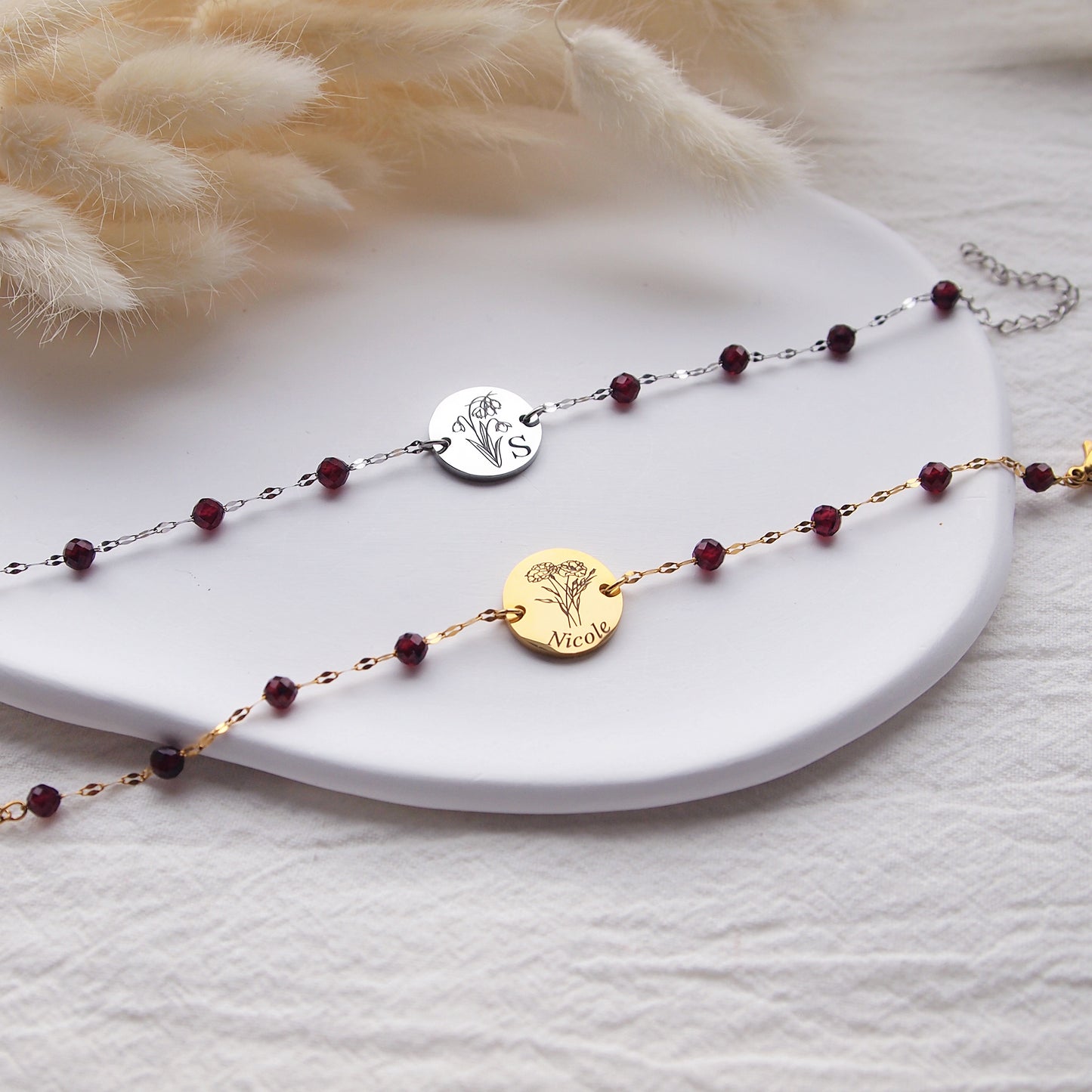 Custom engraved garnet bracelet with january birth flowers and name