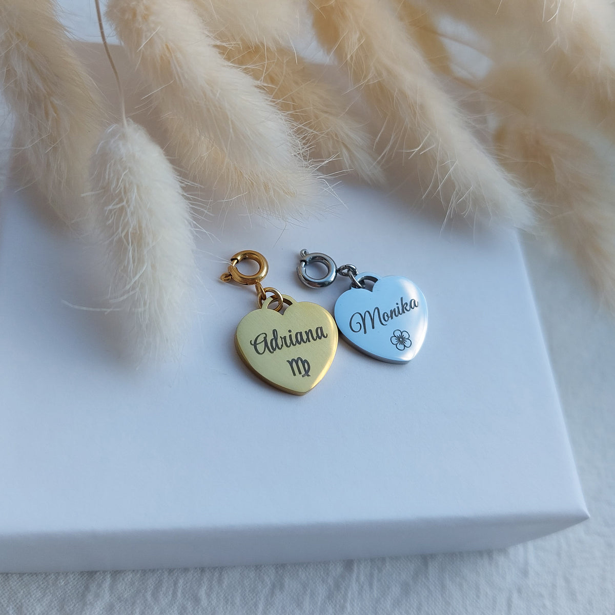 custom personalized stainless steel charms in heart shape, engraved with word or name, can be attached to stretch bracelets, put on chains or other fasteners