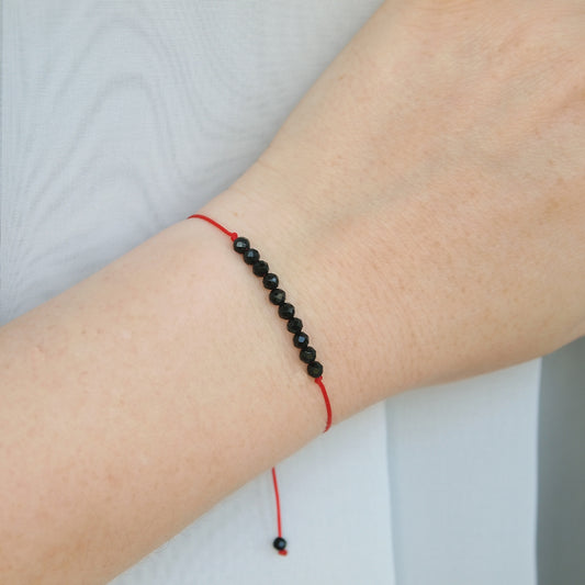 dainty red string bracelet with tourmaline