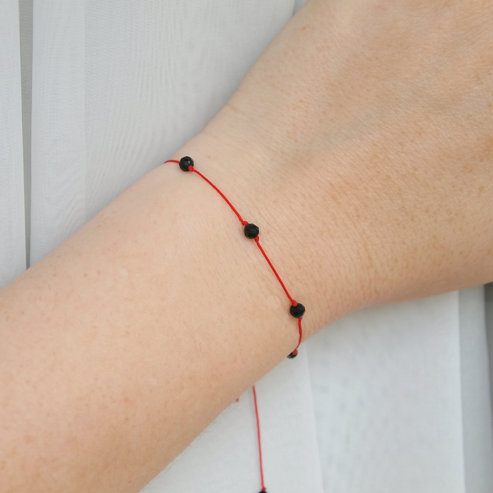 minimal beaded red string protection bracelet