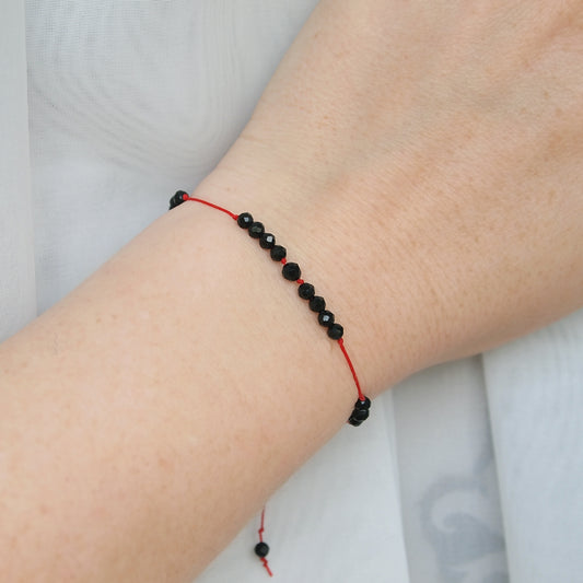 beaded red string protection bracelet with tourmaline