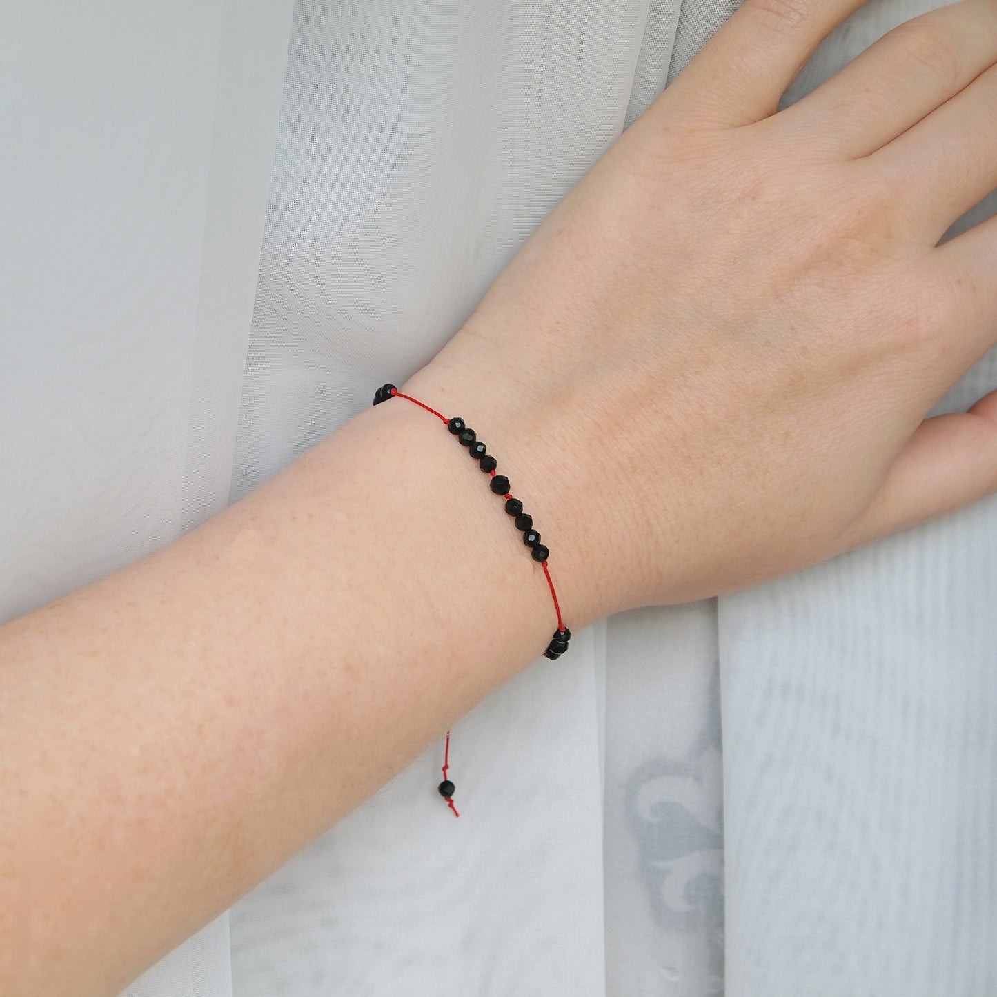 minimal protection bracelet with black tourmaline on red string