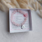 stretchy beaded rose quartz bracelet with heart shaped custom engraved charm, charm is detachable