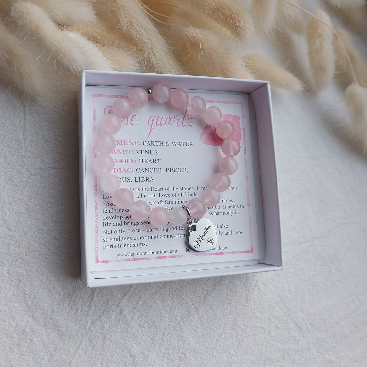 stretchy beaded rose quartz bracelet with heart shaped custom engraved charm, charm is detachable