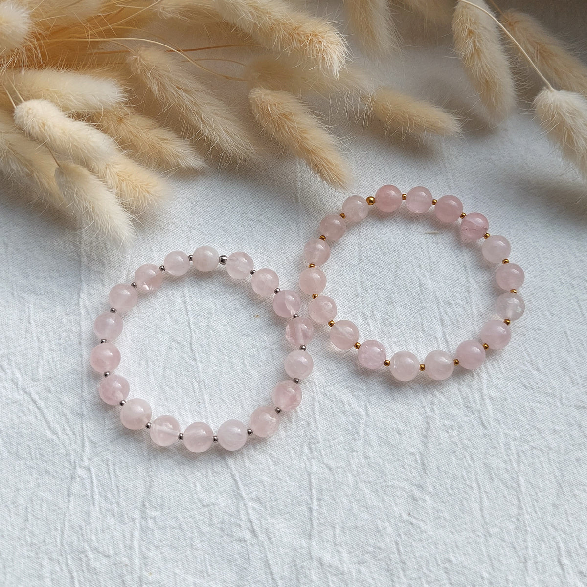 beaded natural rose quartz bracelet on stretch cord, with small stainless steel spacer beads in gold or silver color