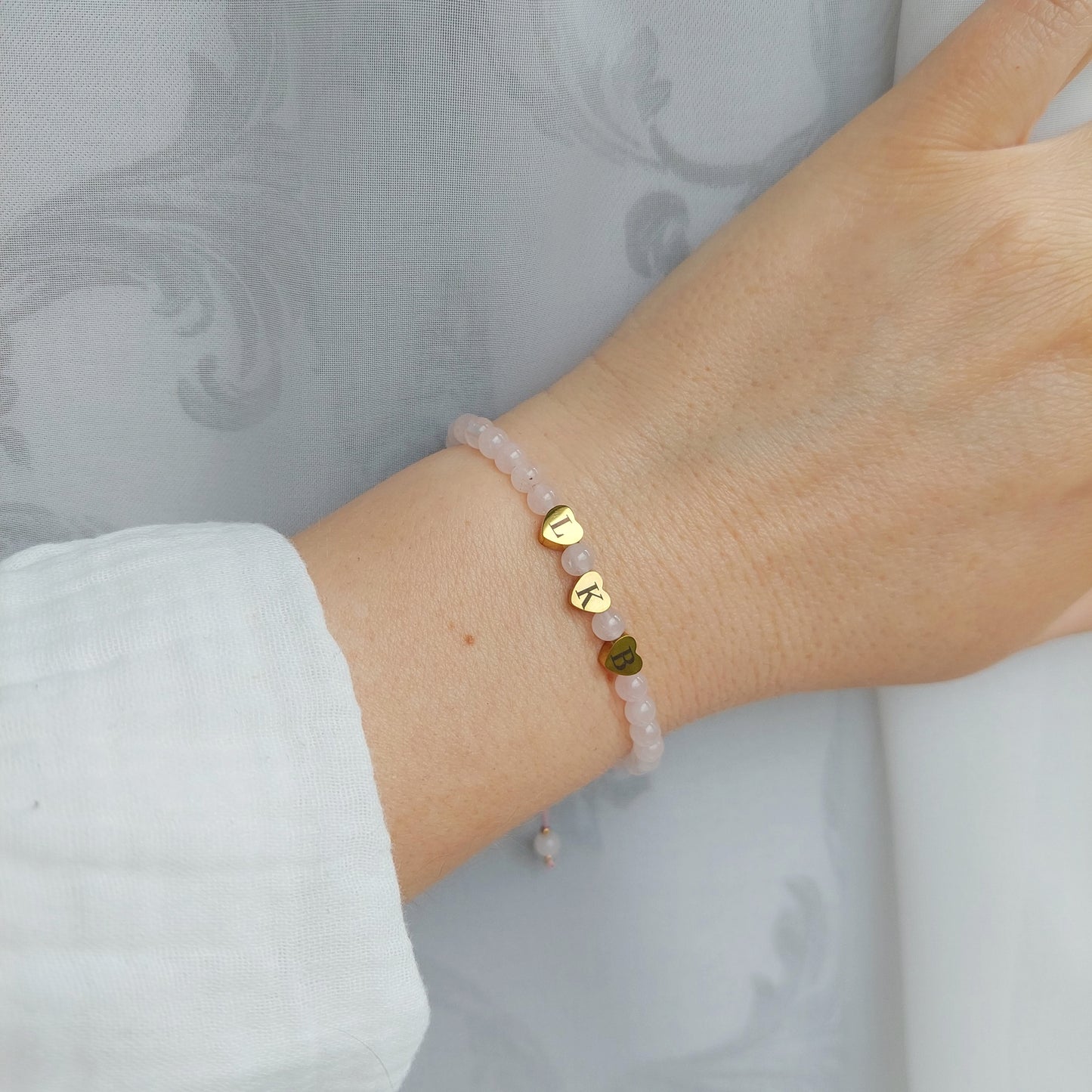 delicate rose quartz bracelet with engraved heart beads