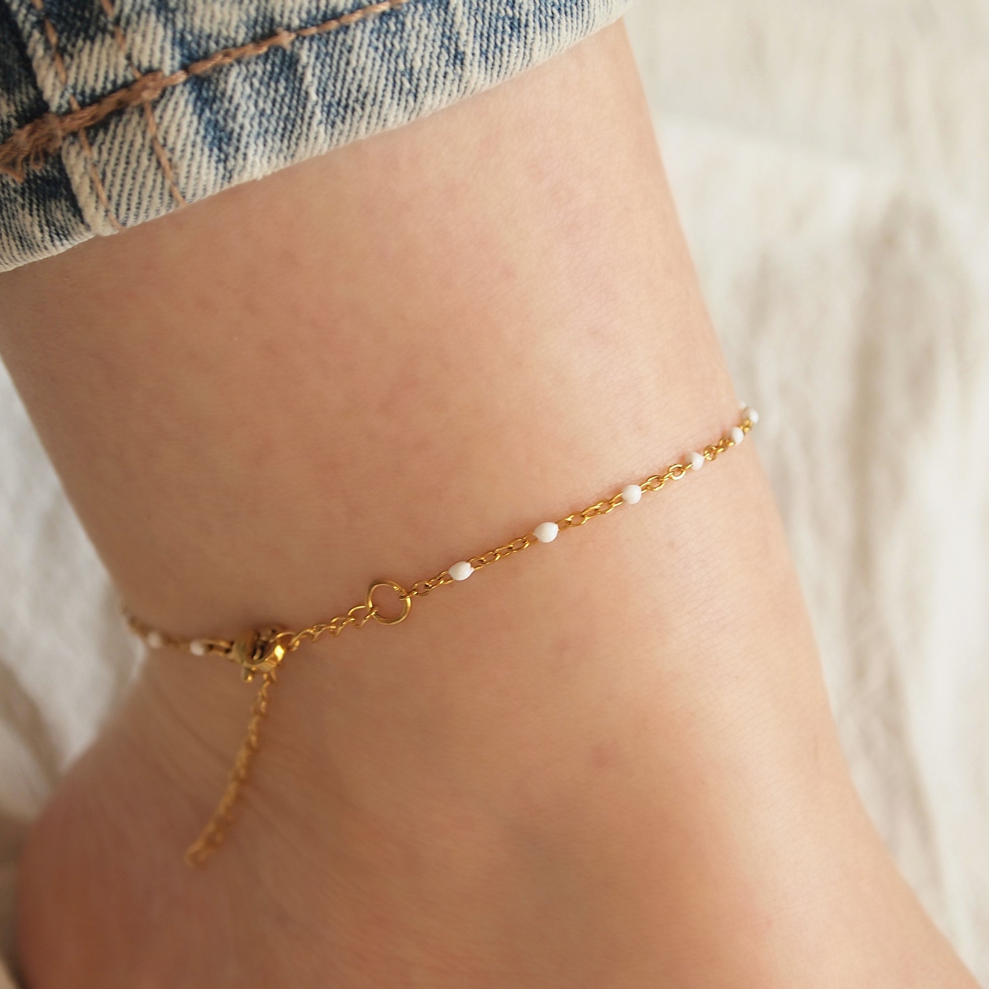 dainty woman ankle bracelet with small white beads